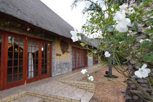 a house with white flowers in front of it at Thabong Bed and Breakfast in Brakpan
