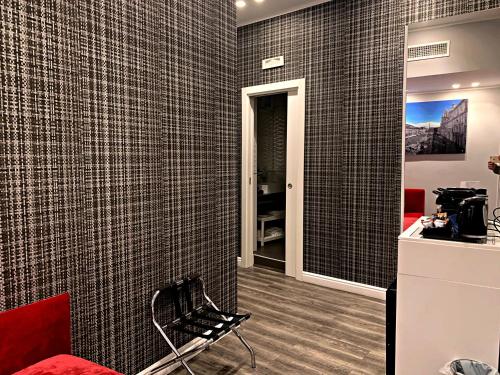 a room with a wall covered in black tiles at MILLINA SUITES IN NAVONA in Rome