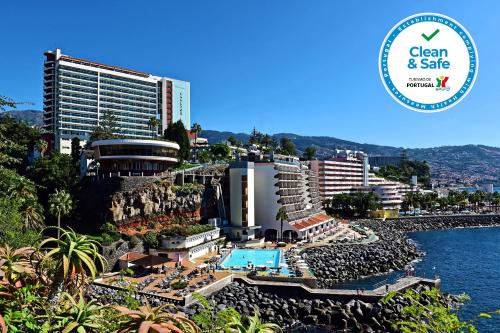 a view of a resort with a pool and buildings at Pestana Madeira Beach Club in Funchal