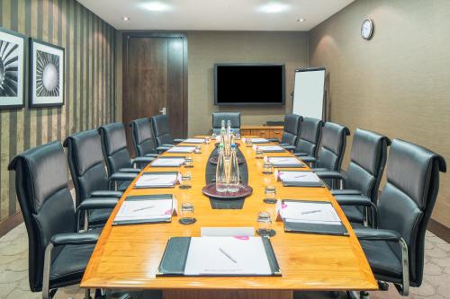 a large conference room with a long table and chairs at Crowne Plaza London - Gatwick Airport by IHG in Crawley