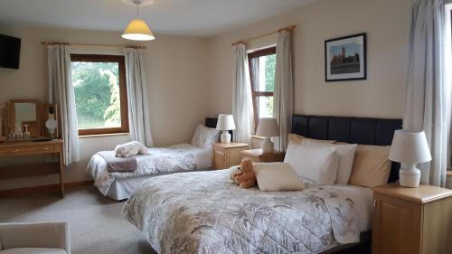 A bed or beds in a room at Corrib View Lodge