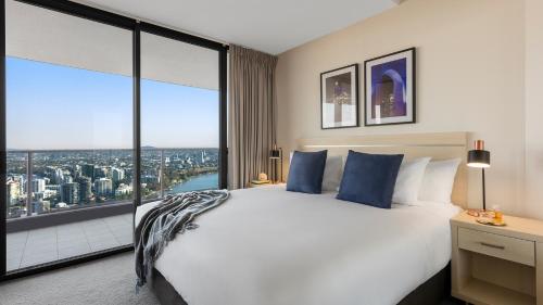 a hotel room with a large window overlooking the ocean at Oaks Brisbane Aurora Suites in Brisbane