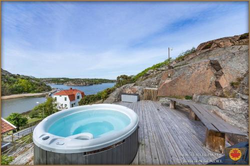 a large bath tub sitting on top of a wooden deck at Hem till Bengt in Kungshamn