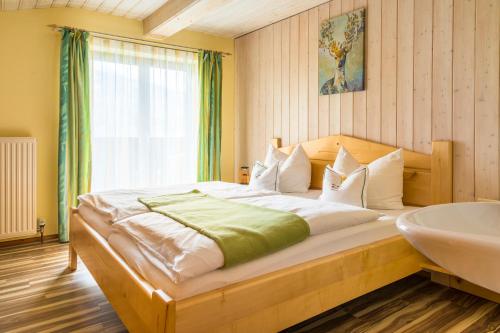 a bedroom with a large bed and a sink at Bio Bauernhof Oberbenk in Wagrain