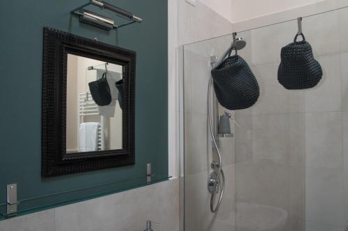 a bathroom with a mirror and a shower at Locanda Fontanazza Osteria con Camere in La Morra