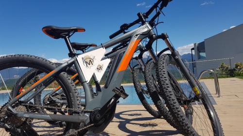 a bike is parked on a bike rack at Aparthotel Malga in Caldaro