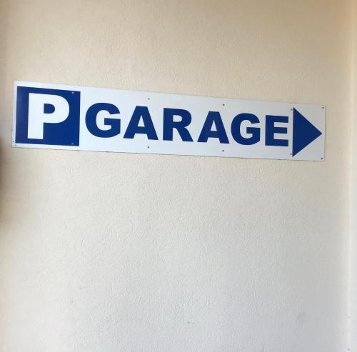 a blue and white sign on a wall at Brit Hotel Europ Bergerac in Bergerac