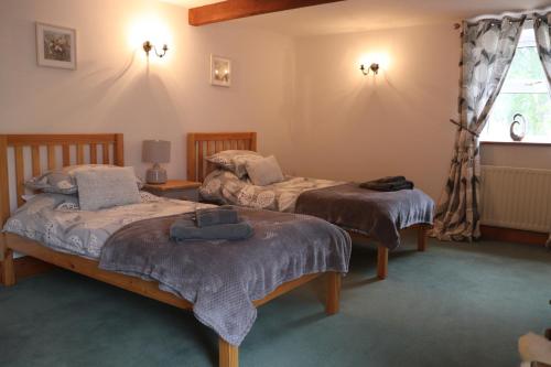 Katil atau katil-katil dalam bilik di Old Camms Holiday Cottages