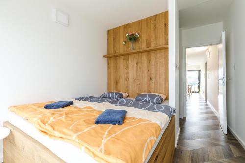 a bedroom with a bed with two blue towels on it at Mountain view apartment in Loučná pod Klínovcem