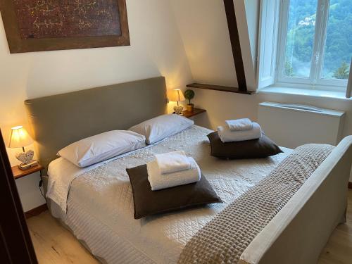 a bedroom with a bed with two towels on it at a magic retreat in Fobello