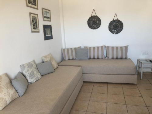 a living room with a couch and a table at Calderimi Apartments in Fira