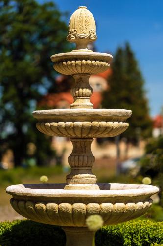 a fountain with a lion on the top of it at Parkhotel Hohnstein by STEIGER Hotels in Hohnstein