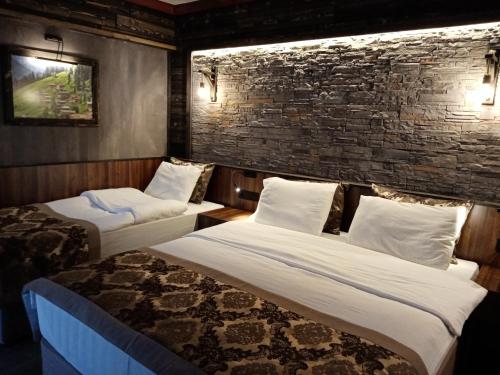 Säng eller sängar i ett rum på SARIGERME NEW GATE HOTEL