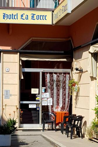 a group of chairs sitting outside of a building at Hotel La Torre in Cogoleto