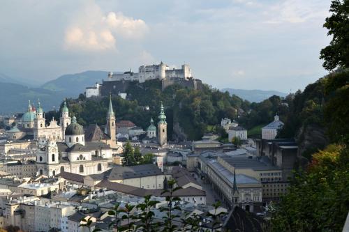 a city with tall buildings and a clock tower at Hotel Hohenstauffen in Salzburg