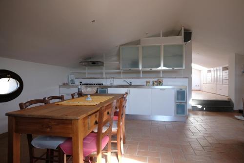 a kitchen with a wooden table and some chairs at Agriturismo Vigna Sul Lago in Montefiascone