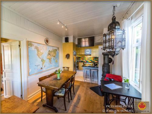 a living room with a table and a map on the wall at Hem till Bengt in Kungshamn