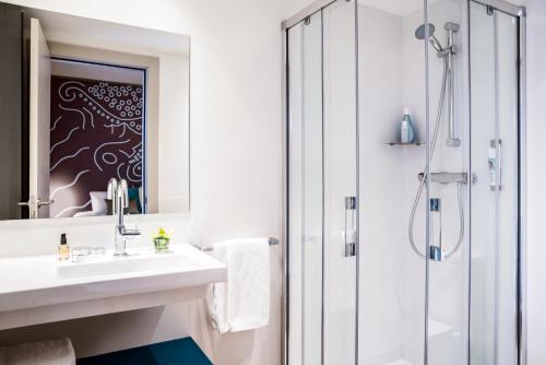 a bathroom with a sink and a shower at ibis Styles Barcelona Centre in Barcelona