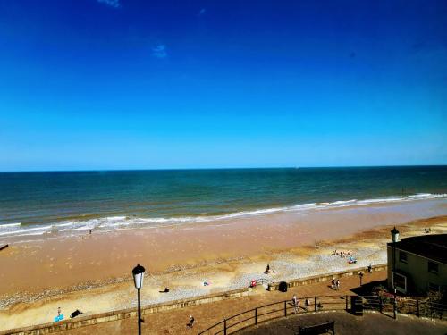 a sandy beach with a few boats on it at The Red Lion Hotel in Cromer