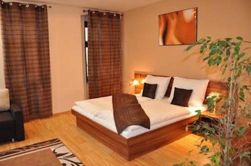 a living room with a bed with pillows at Penzion Beryl in Košice
