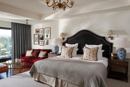 a bedroom with a large bed and a large window at The Gleneagles Hotel in Auchterarder