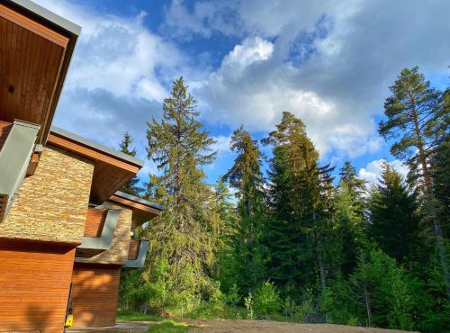 a view of a forest from a house at Borovets Chalets in Borovets
