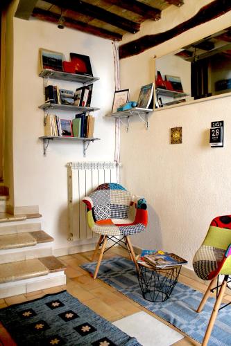 a room with two chairs and a table at Alter Ego b&b Assisi in Assisi