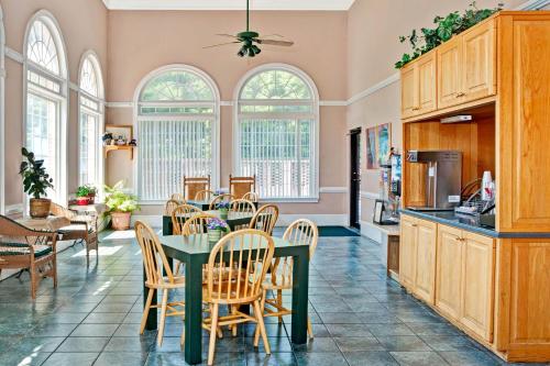 a kitchen and dining room with a table and chairs at Super 8 by Wyndham Marietta/West/Atl Area in Marietta