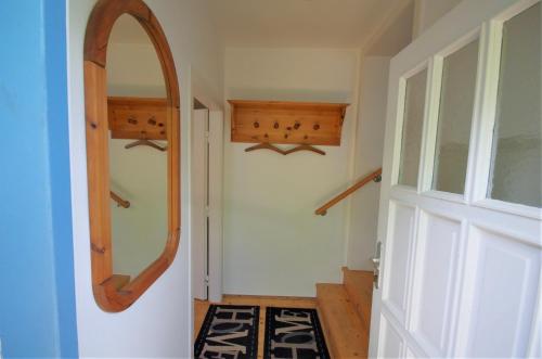 a hallway with an oval mirror on the wall at Stieglerhof KG in Illmitz
