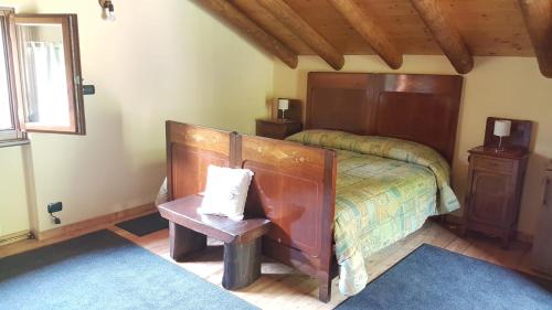 a bedroom with a bed and a table and a window at Baita Eleonora in Argegno
