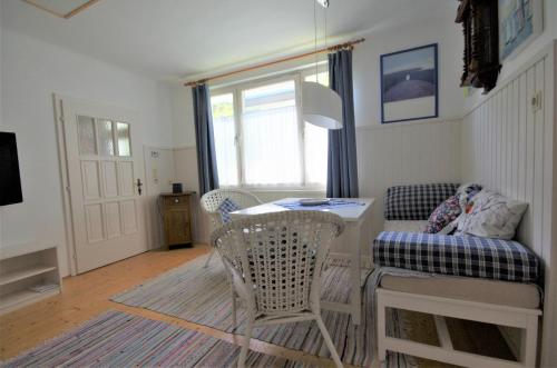 a living room with a table and chairs and a couch at Stieglerhof KG in Illmitz