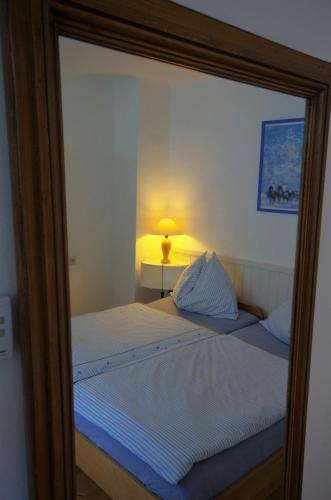 a mirror reflection of a bed in a bedroom at Stieglerhof KG in Illmitz