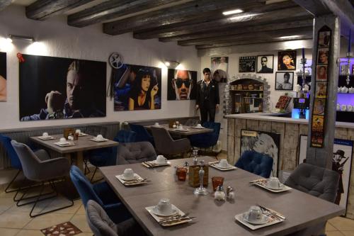 a restaurant with tables and chairs and posters on the walls at Hotel Karthäuser Hof in Flörsheim