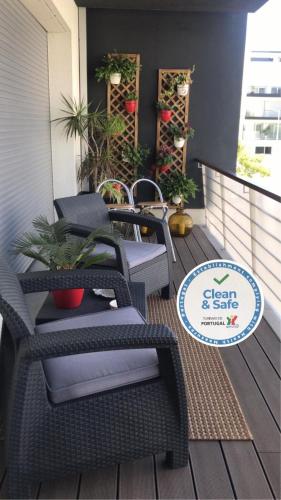 a patio with chairs and plants on a deck at Dream Space Home in Leiria