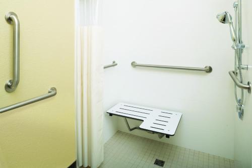 a small bathroom with a bench in a restroom at La Quinta by Wyndham Gillette in Gillette