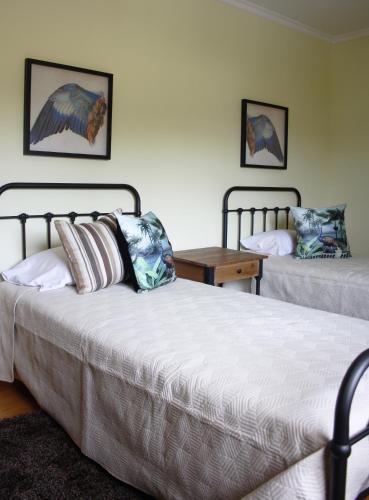 a bedroom with two beds and a table at MR alheira house in Barcelos