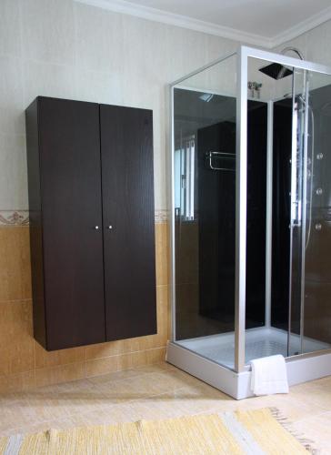 a bathroom with a mirror and a shower at MR alheira house in Barcelos
