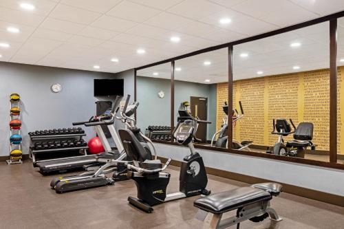 a gym with treadmills and ellipticals in front of a mirror at La Quinta by Wyndham Gillette in Gillette