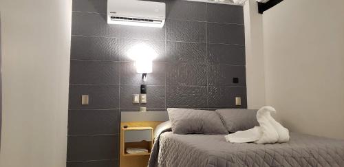 a bedroom with a bed with a white animal on it at El Suburbio - Morelos Sur in Morelia