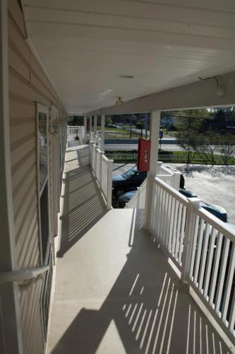 a porch of a house with boats on the water at At 9 Motel in Howell