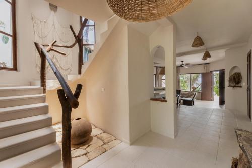 a hallway of a home with a staircase and a hallway at NEST Tulum in Tulum
