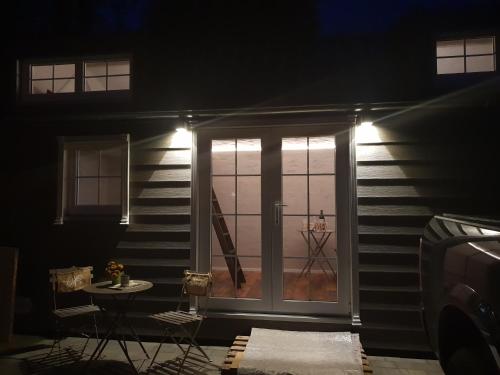 a room with a sliding glass door with a table at Tinyhaus Wolkenlos Familie Hamdorf in Bad Sulza