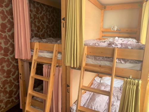 two bunk beds in a room with a bed at Sado - Hotel - Vacation STAY 82483 in Sado