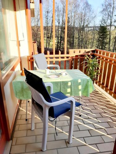 a table and chairs sitting on a balcony at Apartment Anja in Schluchsee