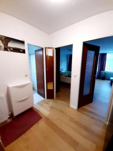 an empty room with two doors and a bedroom at Apartment Anja in Schluchsee