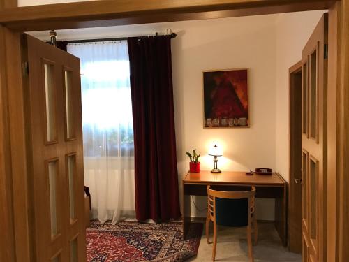 a home office with a desk and a window at Antik Hotel Sofia in Litomyšl