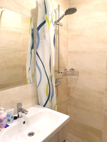a bathroom with a sink and a shower at Променад "MAXXSEA" in Zatoka