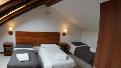 a bedroom with two beds in a attic at appartamenti la ginestra in Cesana Torinese