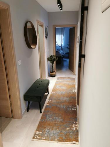 a hallway with a rug and a green ottoman at Romana Dream apartment in Vrsar