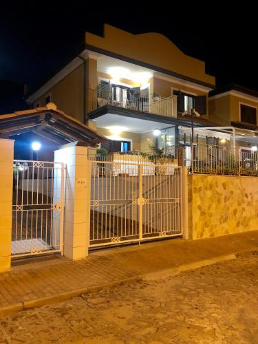 a gate in front of a house at night at Residenza De Luca Apartment in Tropea